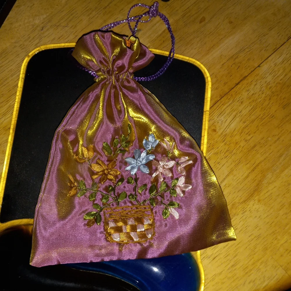6x8 pretty detail flowers silky like material bag string closure.